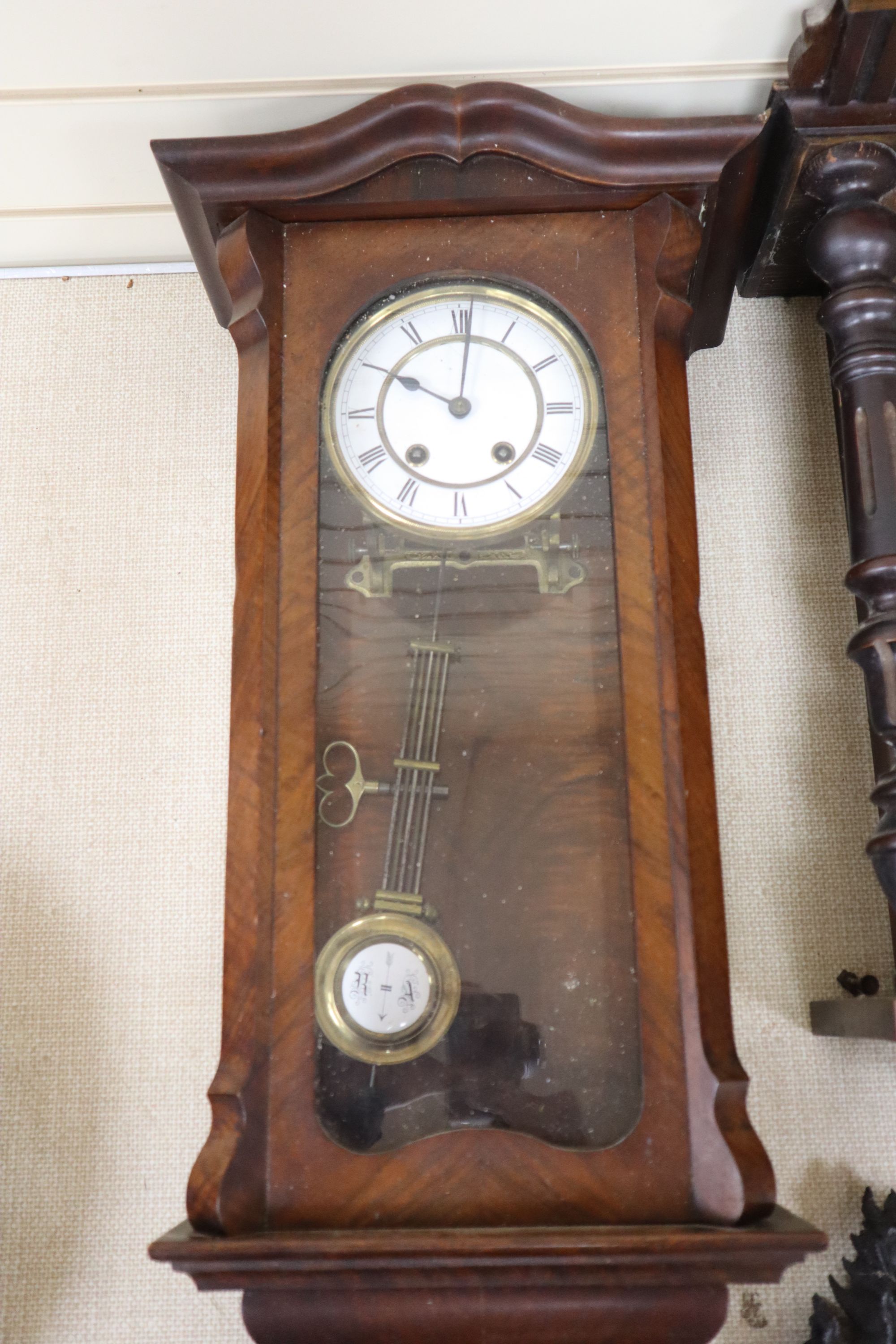 A walnut Vienna regulator with enamelled Roman dial and another regulator with carved pediment, largest 75cm